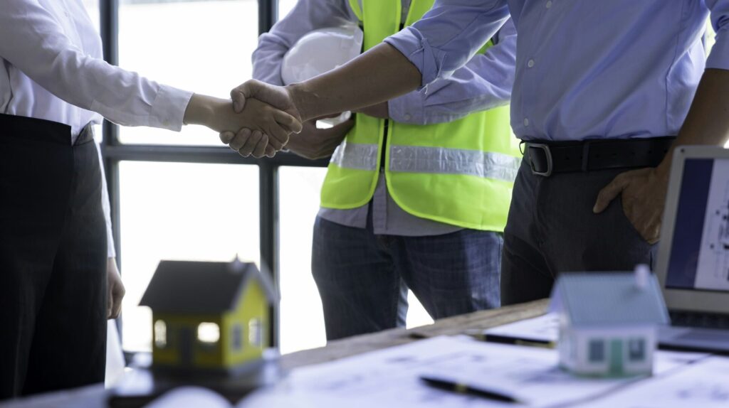 Architect shakes hands at meeting, meeting of two engineers or architects, shaking hands after discu