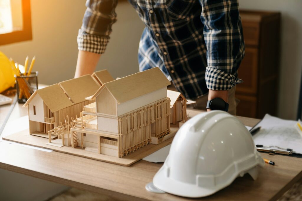 Professional architect, engineer or interior reviewing blueprint on workplace desk