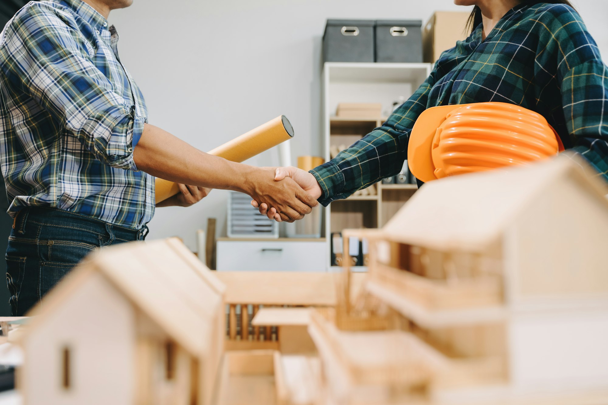 Engineer desk with object paper and tablet with blurry engineer teamwork hardworking