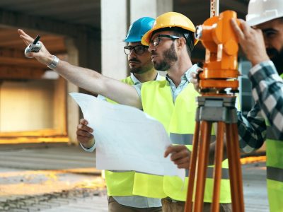 Construction engineers discussion with architects at construction site