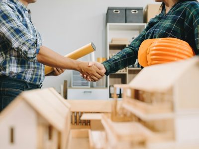 Engineer desk with object paper and tablet with blurry engineer teamwork hardworking